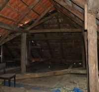 The attic of a family house with wooden beams, ideal for renovation and storage space.