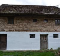A family house in Bukovec with brick walls and a wooden roof in the countryside.