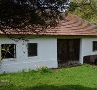 A family house in Bukovec with a sloped roof and wooden gates.