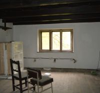 Interior of a family house with a wooden decor floor and a chair under the window.