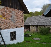 A family house in Bukovec with traditional brick and stone buildings, garden table.