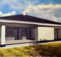 A family house in Dúbravka with a flat roof, terrace, and surrounding greenery.