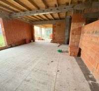 Unfinished family house in Dúbravka with a wooden ceiling and brick walls.