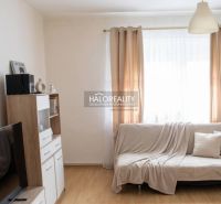 Living room in a family house with a wooden decor floor and light curtains.
