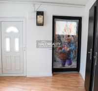 The interior of a family house with white doors and a floor with a wood decor.