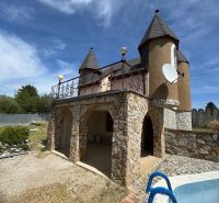 A house on Agátová Street in Šahy with a stone facade and a small pool in the front.
