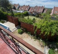 The view from the terrace of the cottage on Agátová Street in Šahy with swaying bushes.