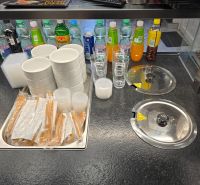 Interior of dining spaces with drinks, glasses, bowls, and cutlery ready for serving.