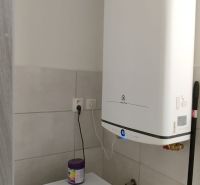 Washing machine and boiler in the bathroom of a 2-room apartment with a practical layout.