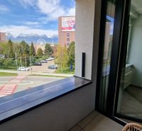 View from a 2-room apartment on Karpatská Street in Poprad with snow-covered mountains in the background.