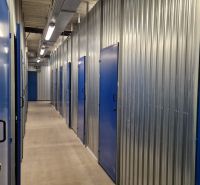 Storage spaces with blue doors and steel walls in a 2-room apartment.