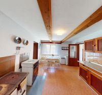 A kitchen in a family house with wooden elements and a cooking stove.
