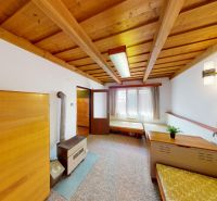 The interior of a family house with a wooden ceiling and furniture with a wooden decor.