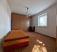 Bedroom with a bed and built-in wardrobe in a family house.