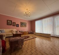 Living room in a family house with a wooden decor floor and comfortable seating.