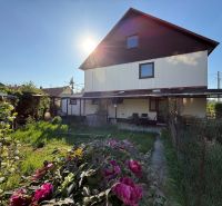 A family house in Zlaté Moravce with a blooming garden and a lush lawn.