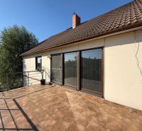 A family house in Zlaté Moravce with a terrace and brown roofing.