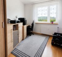 A workspace with a chest of drawers and a view from the window in a 3-room apartment.