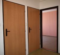 Interior of a 3-room apartment with doors featuring a wooden decor and a telephone on the wall.