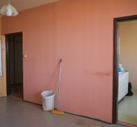 Interior of a 3-room apartment with colorful walls and a kitchen unit.