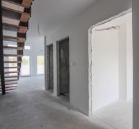 Interior of a 4-room apartment with a staircase and large windows, neutral wall colors.