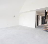 Interior of a 4-room apartment with a concrete floor and wooden staircase.
