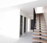 Staircase and entrances in a 4-room apartment with a wooden decor floor.