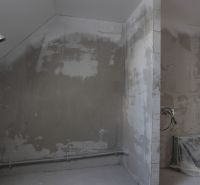 An unfurnished room in a 4-room apartment with rough plaster and preparation for installations.