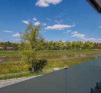 View from the balcony to greenery and the river on Moravanská Street in Banka.