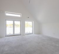 An unfurnished room with large windows in a 4-room apartment.