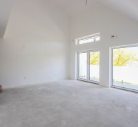 Interior of a 4-room apartment with an empty room, large windows, and stairs with a wooden decor.