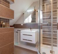 A bathroom in a 4-room apartment with elegant tiles and a shower corner.