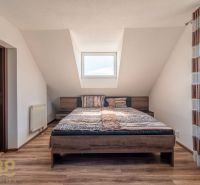 A stylish bedroom with a large bed and a wooden decor floor in a 4-room apartment.