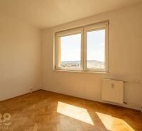 A room with a window, a radiator, and a wooden decor floor in a 4-room apartment.