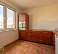 A kitchen unit in a 4-room apartment with a large window and built-in appliances.
