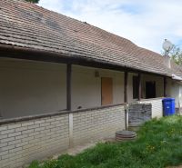 The exterior of a family house in Horné Saliby with a gable roof and brick cladding.