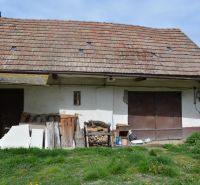 A family house in Horné Saliby with an old roof and an unmaintained exterior space.