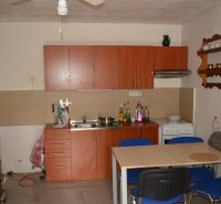 A kitchen in a family house with a dining table and wooden furniture.