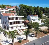 A holiday apartment in Brač with a sea view and surrounding greenery.