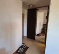 Hallway with a large mirror, footwear, and tiles in a Holiday Apartment.