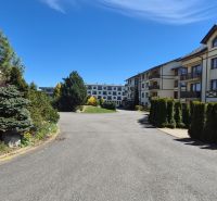The exterior of a holiday apartment in Stará Lesná near the High Tatras with landscaped greenery.