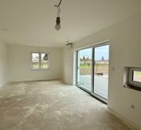 The family house has a spacious room with white walls and sliding doors.