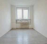 A room in a 3-room apartment with a wooden-patterned floor and white walls.