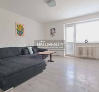 Living room with a sofa and a wooden decor floor in a 3-room apartment.