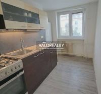 A kitchen in a 3-room apartment with a gas stove and a floor with a wood decor.