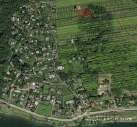 Aerial view of recreational plots in Nova Kelc, surrounded by greenery and buildings.