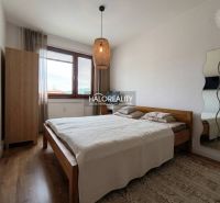 A bedroom in a 3-room apartment with a bed and a wooden decor floor.