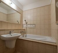 Bathroom in a 3-room apartment with a bathtub, sink, and a large mirror on the wall.