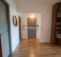 A hallway in a 3-room apartment with a wood-patterned floor and a built-in shelf.