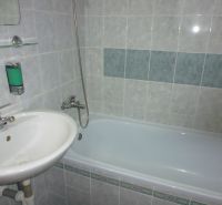 Bathroom in a 2-room apartment with a bathtub and a sink.